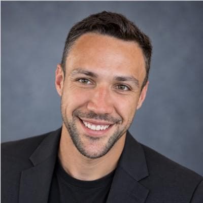 Garret Grant, smiling in a dark blazer